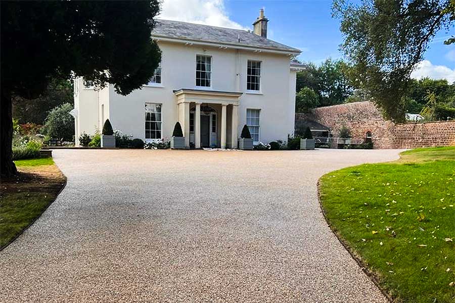 Large driveway covered with Addagrip Terrabase Rustic resin bound gravel in Beach colour