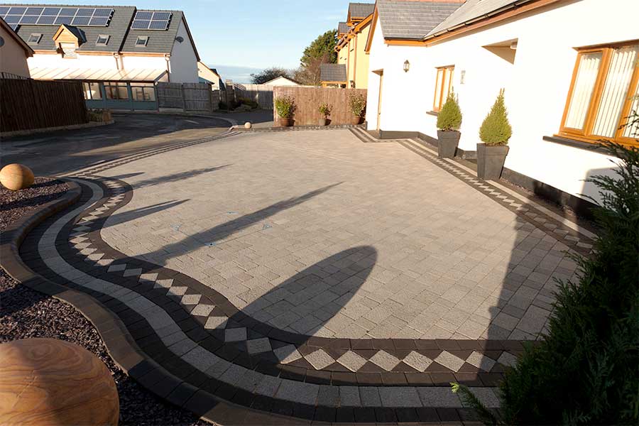 Modern Brett Aura block paved driveway with dark contrasting edging bricks