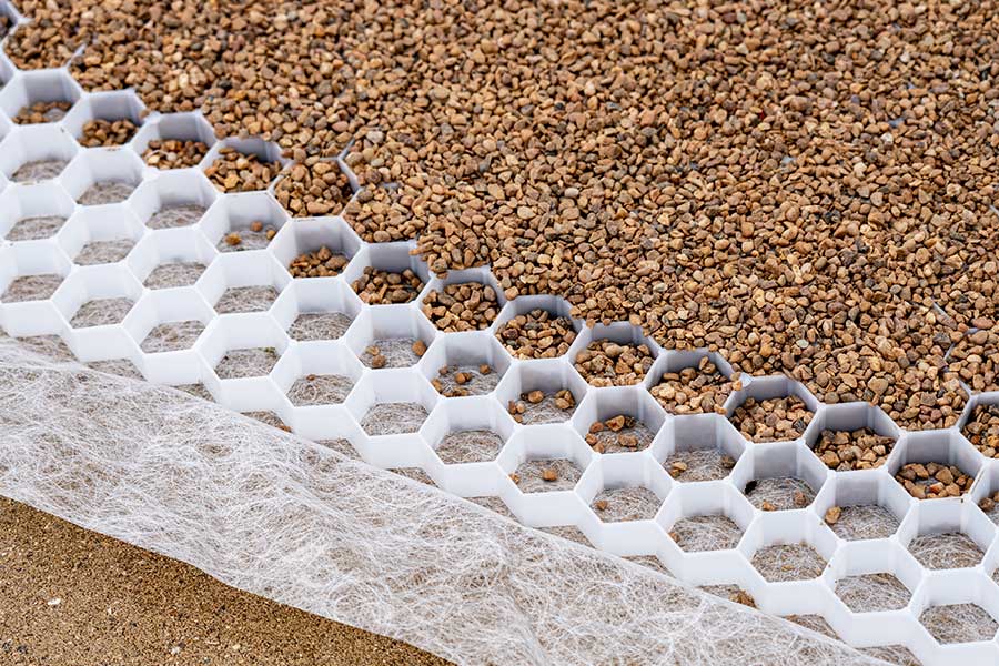 Section image of a Core Drive plastic gravel grid part filled with gravel