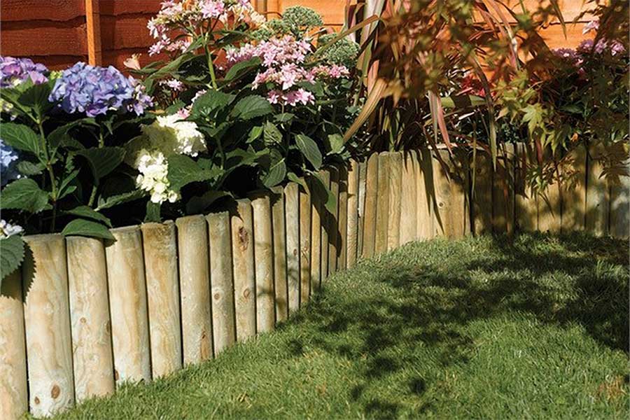 Attractive flower bed with log roll garden edging