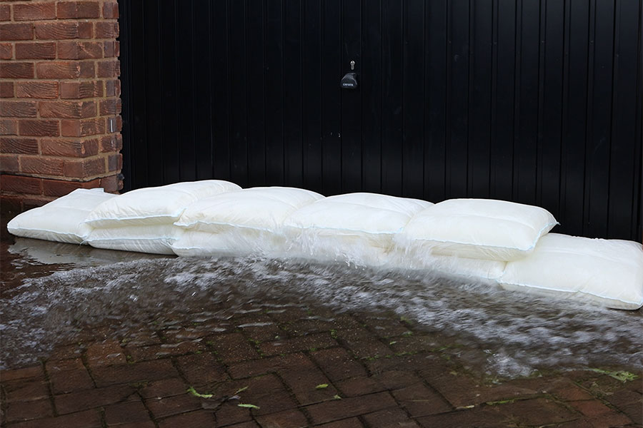 Fernco Floodbags blocking surface water from entering a garage door