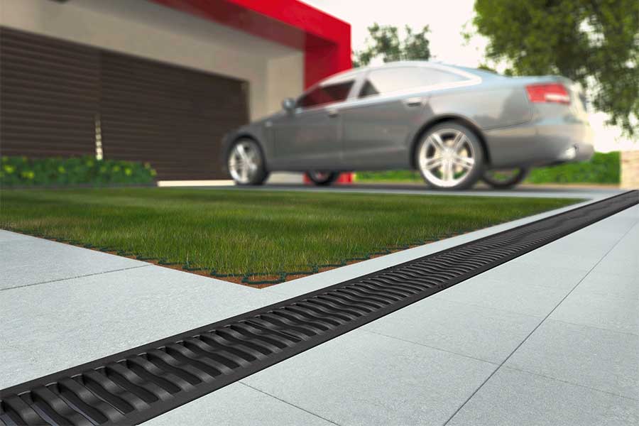 Driveway with added drainage channels allowing surface water to drain to a soakaway 